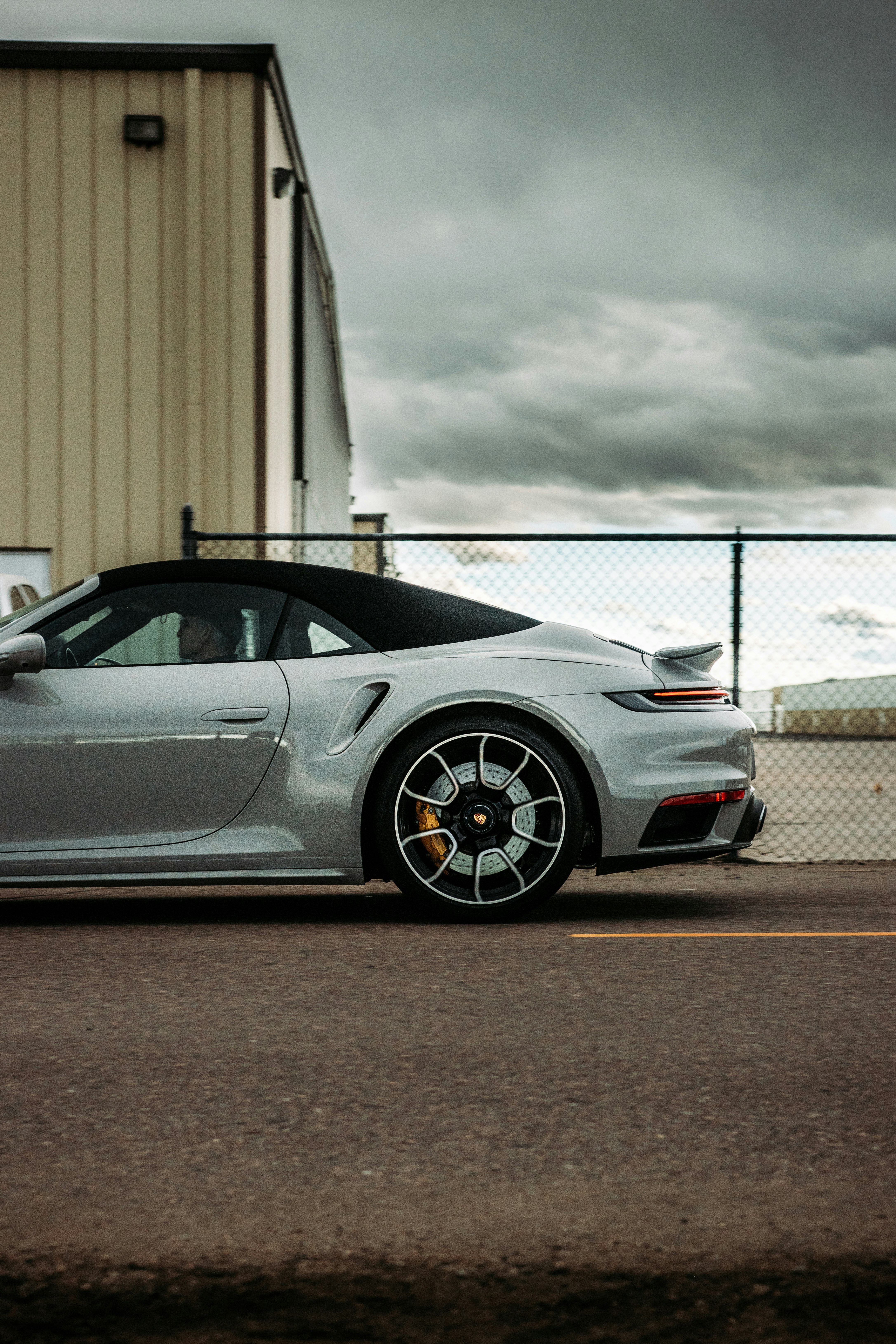 white porsche 911 parked near white building